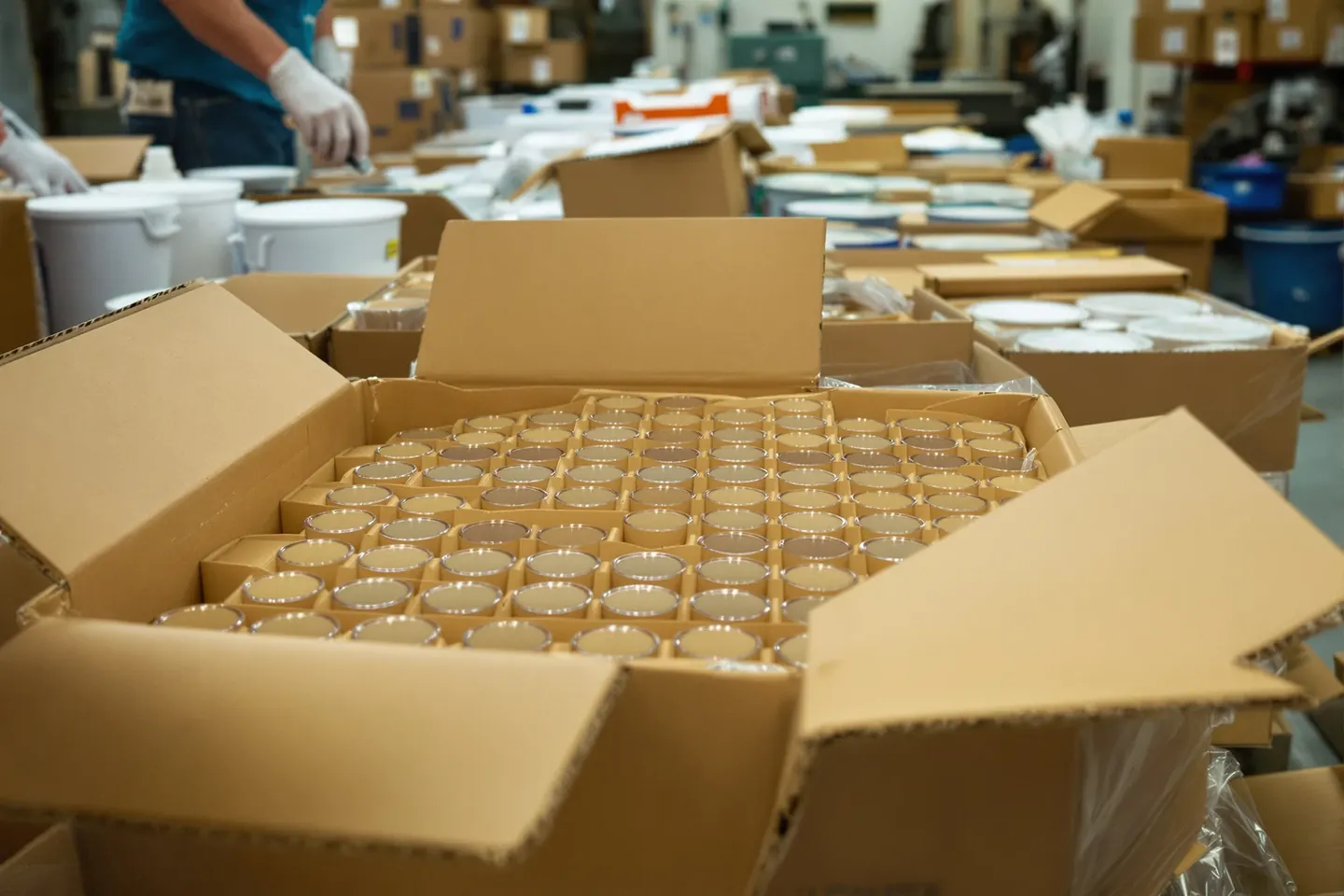 Glass tumblers in cardboard cell dividers inside export cartons