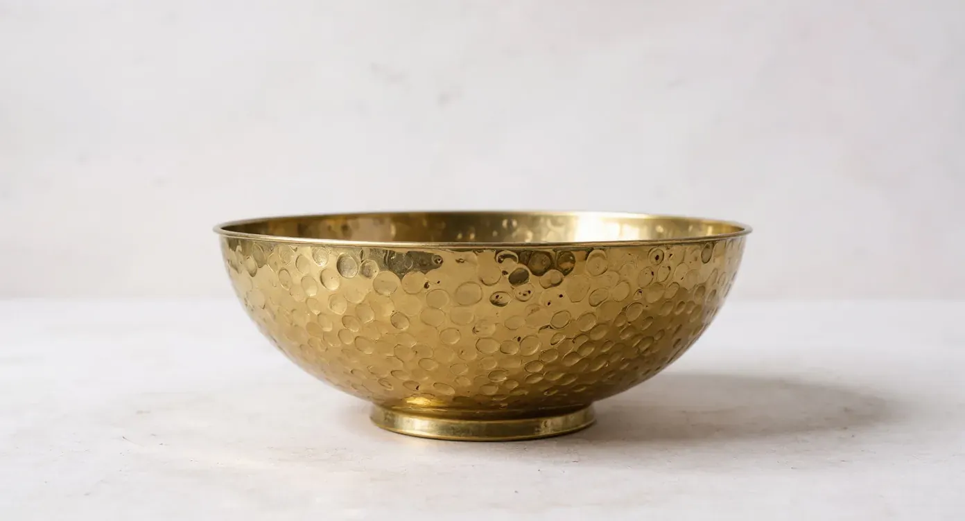 The same brass bowl as a clean catalog packshot on an off-white background